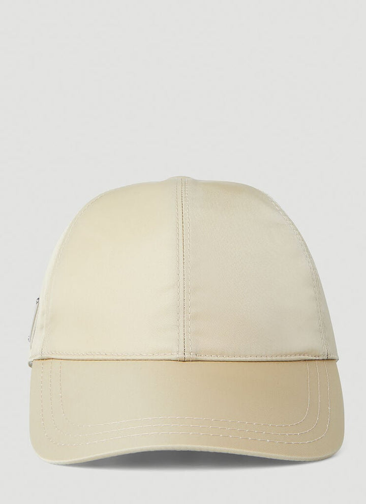 PRADA LOGO BADGE BASEBALL CAP IN BEIGE